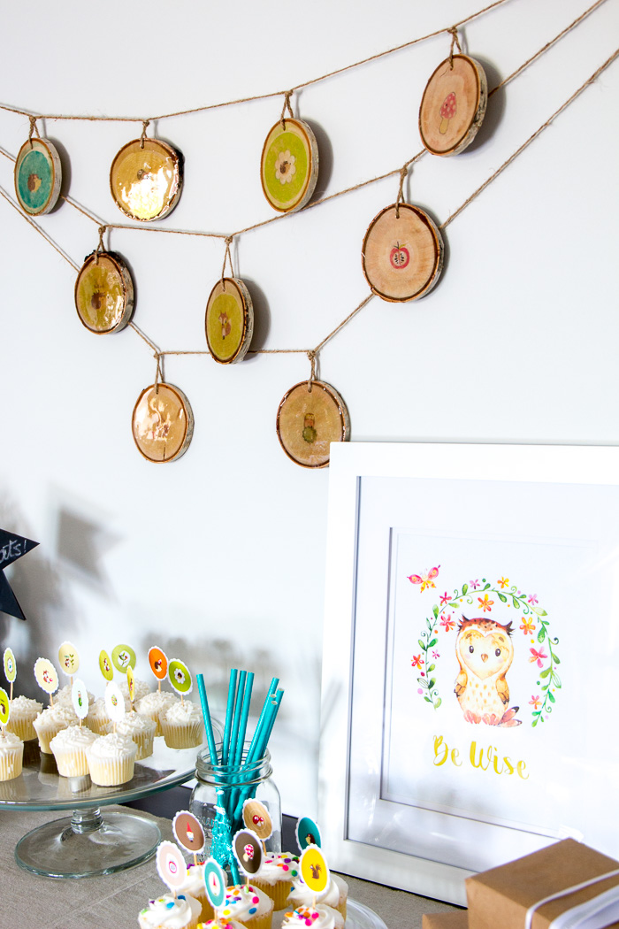 Woodland nursery decor ideas and woodland baby shower decorations. A step-by-step tutorial is included to make the rustic wood slice garland!