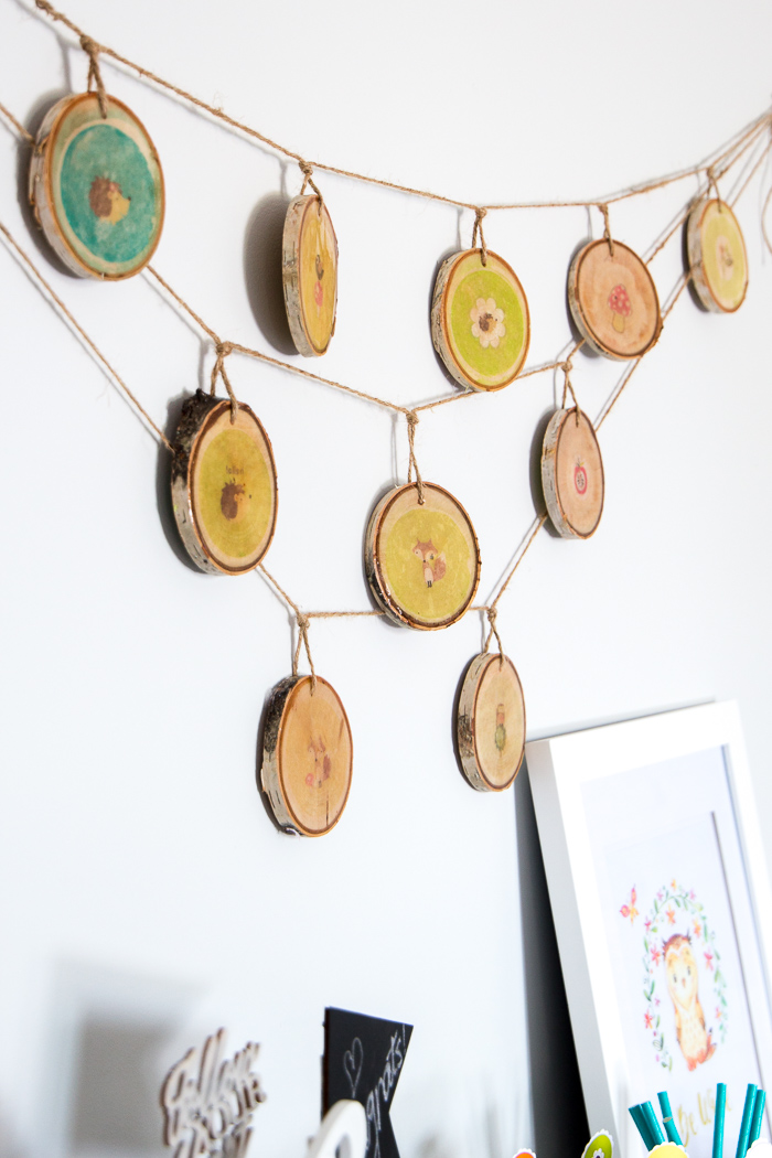 Lovely woodland nursery decor idea! Wood slices with woodland creature images and coated with resin. Step-by-step tutorial is included!