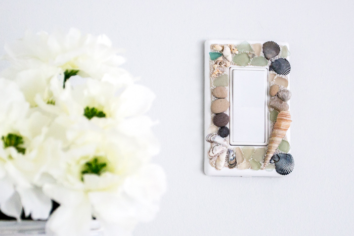 Learn how to make your own beachy decorative switch plates with sea glass, stones and shells. An easy way to embellish those light switch covers for a coastal vibe!
