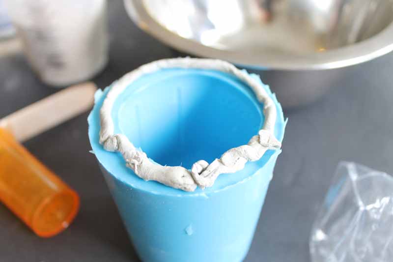Make a concrete mason jar planter with a few supplies! You will love the results!