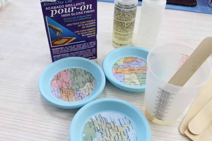 Make these DIY map coasters for your home! Use terra cotta saucers for coasters that look great indoors or out!