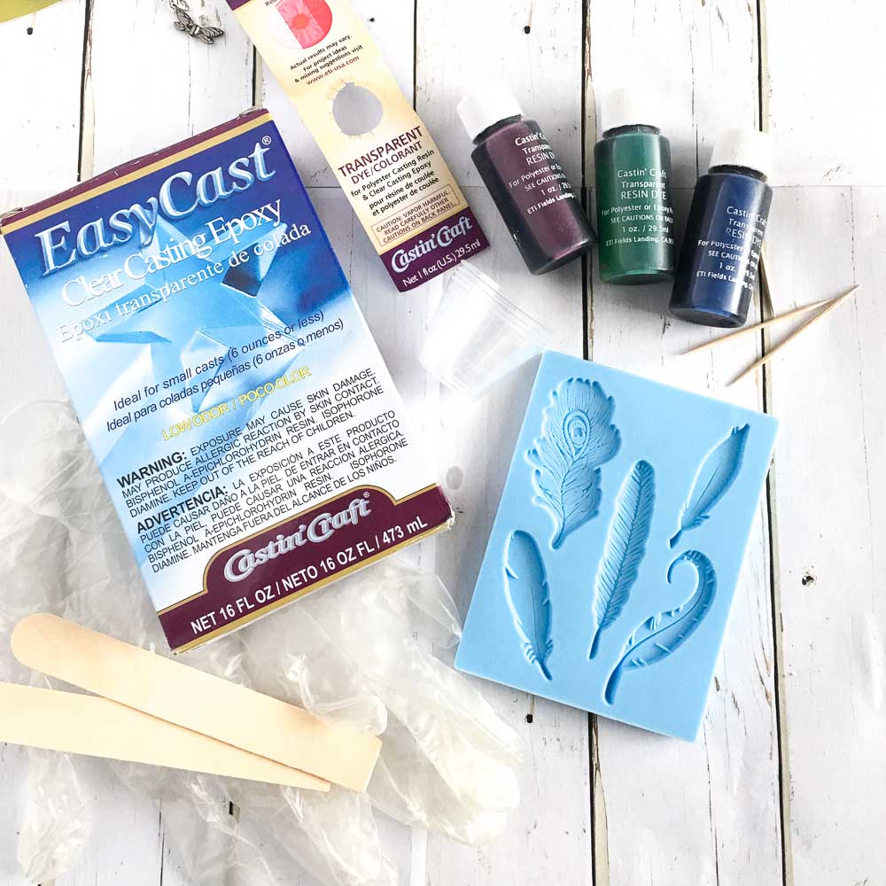 Supplies needed to make water-color inspired feather resin pendants #easycast