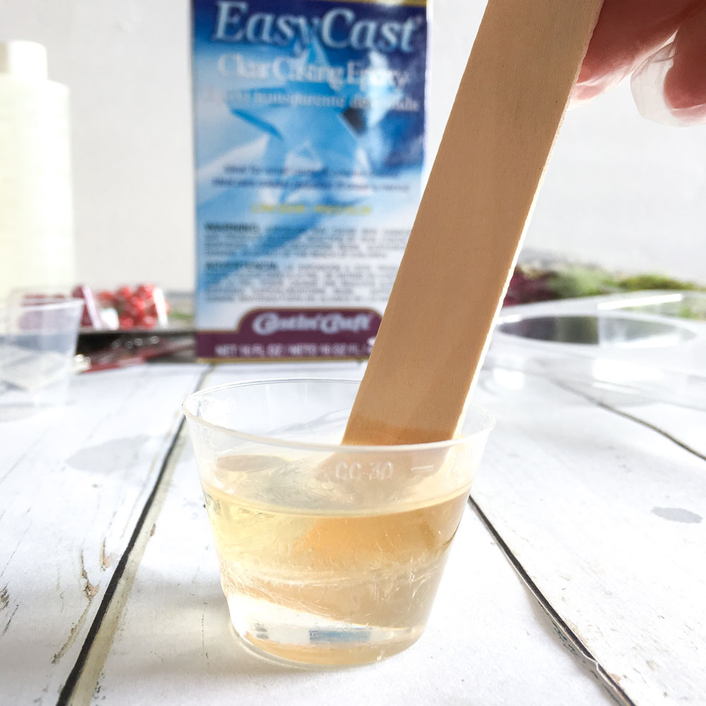 Mixing equal parts of EasyCast Clear Casting Epoxy in a small measuring cup