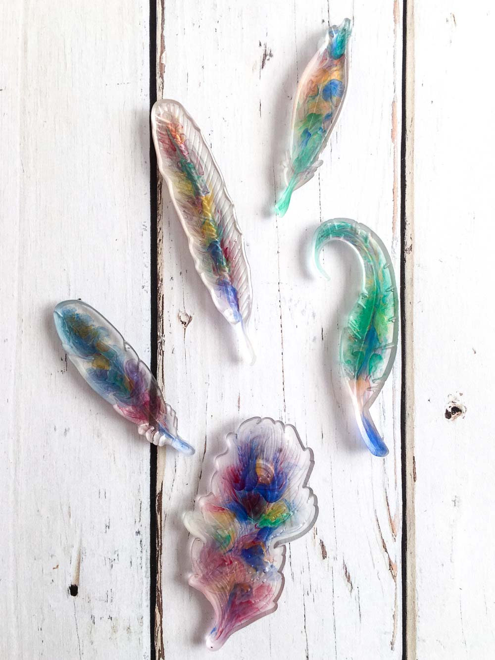 Multi-colour feather-shaped pendants made with EasyCast epoxy resin. 