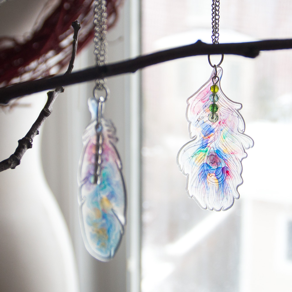 Beautiful pendants made from resin. Clear EasyCast epoxy resin feather pendants with a faux watercolour effect.