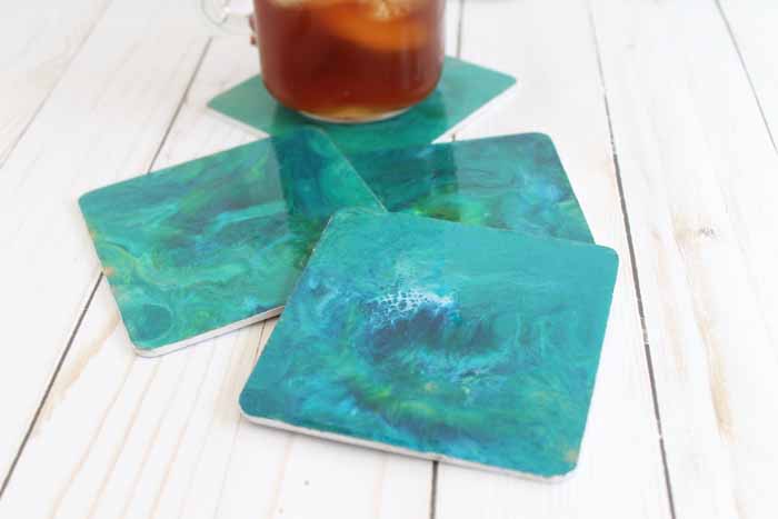 Resin poured marble coasters are the perfect addition to your home! Here we have used sea themed colors but you can mix and match any colors that work with your home decor for this easy resin pour project!