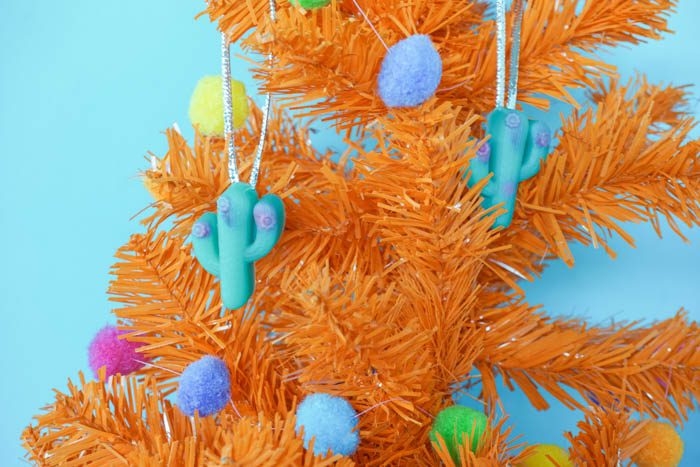 close up of resin cactus ornaments on a colorful tree