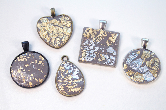 Repeat the process by adding jewelry clay with gold and silver leaf on the pendant bezels