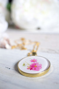 Thoughtful DIY resin jewelry idea. Learn how to make this birth month flower pendant with floral photos and resin. A beautiful birthday, Mother's Day or Christmas gift idea for her.
