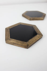 Make your own modern hexagon coasters. Love the look of the wood against the shiny black resin!
