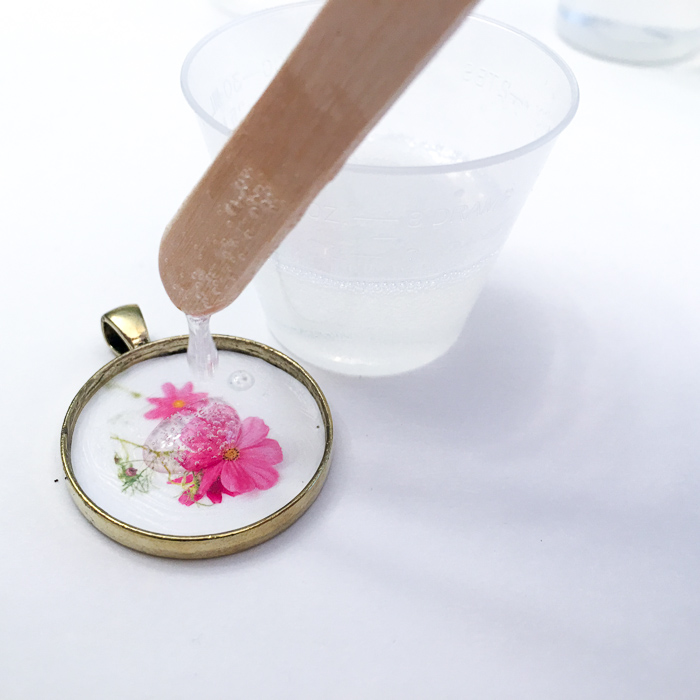 DIY resin jewelry. Tutorial to make your own flower of the month pendant. via @resincraftsblog