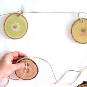 Stringing and tying together wood slices for a DIY garland
