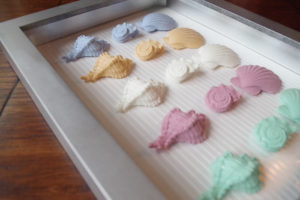 Resin Seashell Wall Art - lined background with scrapbook paper in shadowbox frame
