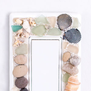 DIY beach-themed decorative switch plate covers with sea glass, stones and shells. An easy way to embellish those light switch covers for a coastal vibe!