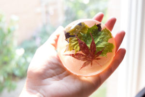 DIY resin paperweight made with maple leaves in different colours.