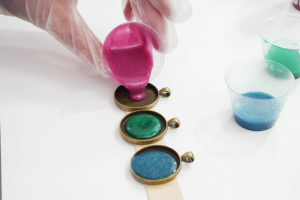 Sparkling Dripped Resin Pendants - add metallic paint to resin - pour first color into each bezel