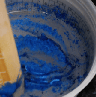 blue mica powder being mixed into epoxy
