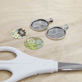 DIY paper and resin pendants - cut paper into circles to fit in bezels