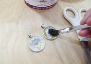DIY paper and resin pendants - glue paper into bezels by coating over paper