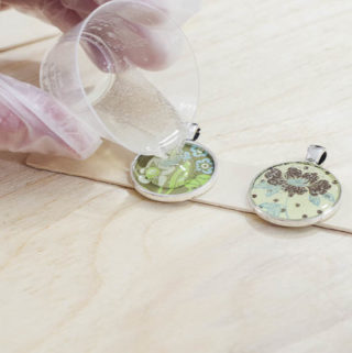 DIY paper and resin pendants - pour jewelry resin into the bezels over paper