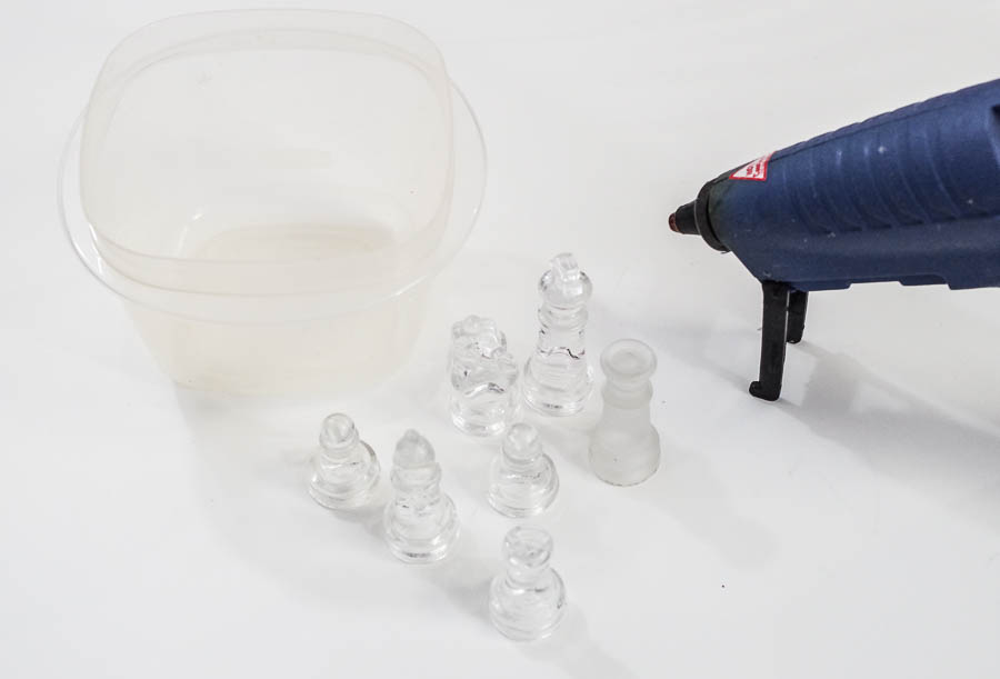 DIY Resin Chess Pieces- gather container, pieces and glue gun via @resincraftsblog