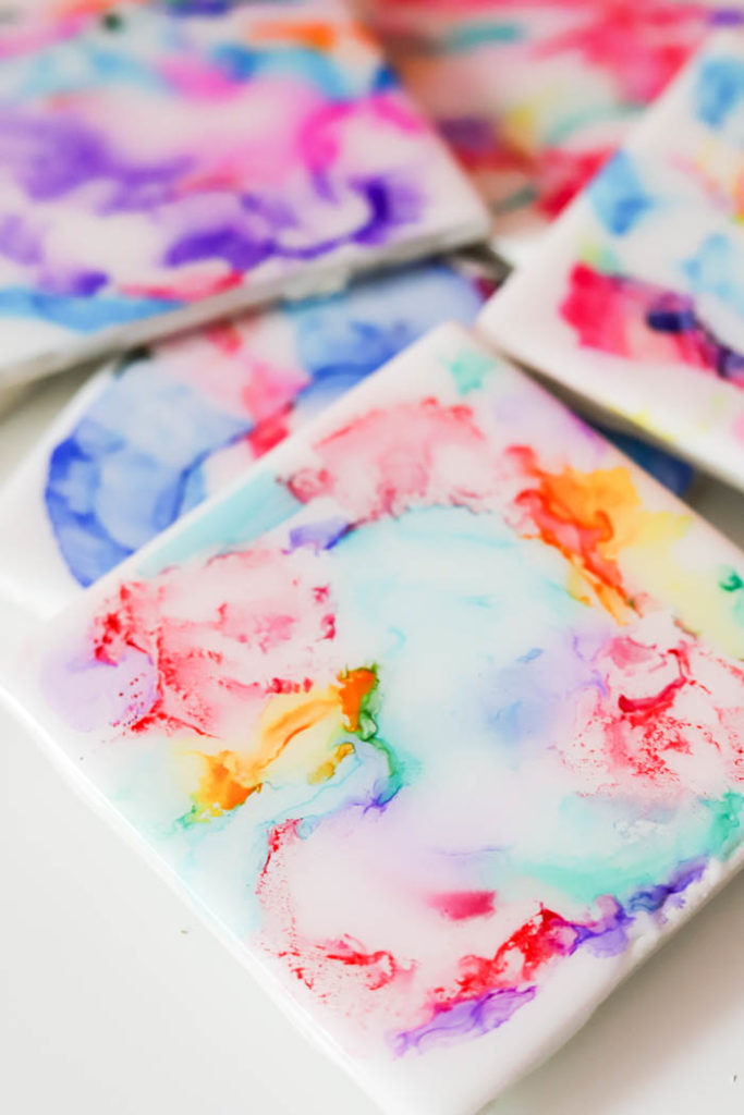 Create colorful coasters with markers, isoprophyl alcohol, and a lighter then coat with EnviroTex Lite® Pour On High Gloss Finish.