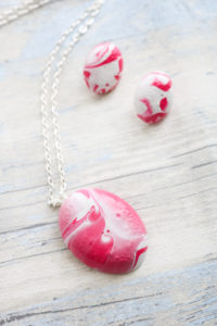 Make an Easter egg necklace and earrings with this simple DIY tutorial and fast cast resin. Includes instructions for adding marbling paint to your craft project! #marbled #easter #spring
