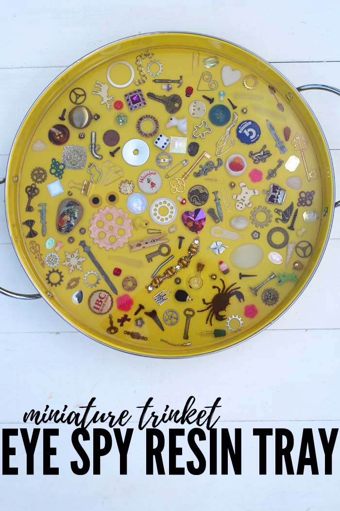 Eye Spy Trinket Tray with EasyCast Resin is such an epic piece. This trinket filled eye spy tray is the perfect craft for making a conversation piece and game for the kids. It's not just for the kids...it's fun for everyone to see what's embedded in the resin.  #resincrafts #eyespytray via @resincraftsblog
