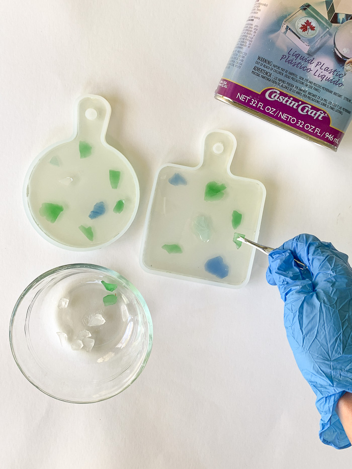 Use tweezers to place sea glass into the soft resin.