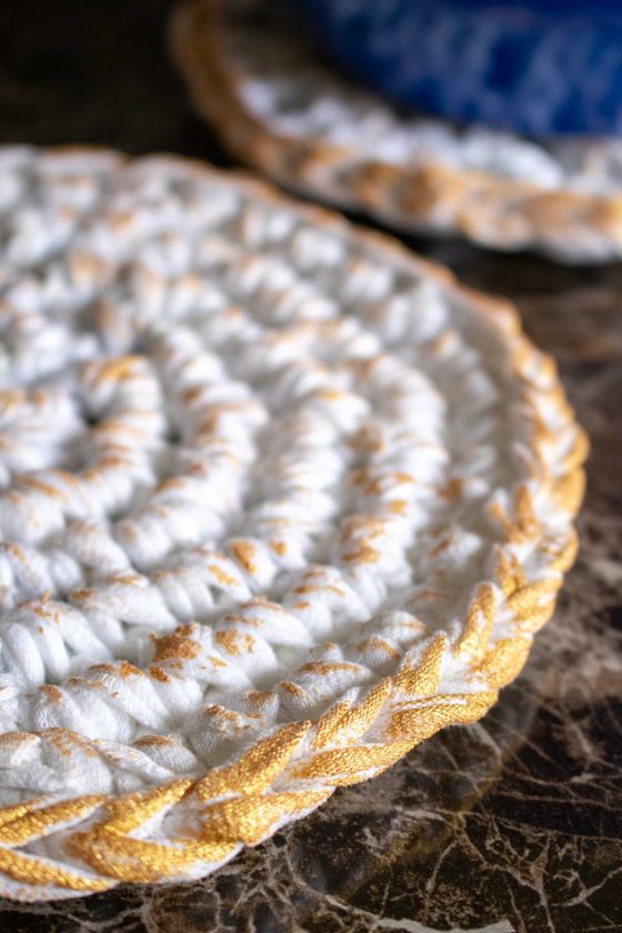 Close up image of the edge of the gold-painted t-shirt yarn heat pad.