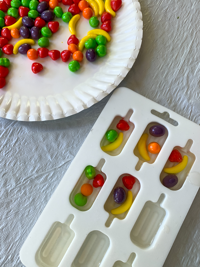 Resin popsicles made with Runts candies are so adorable! See how to turn them into darling resin napkin rings for your summer table.