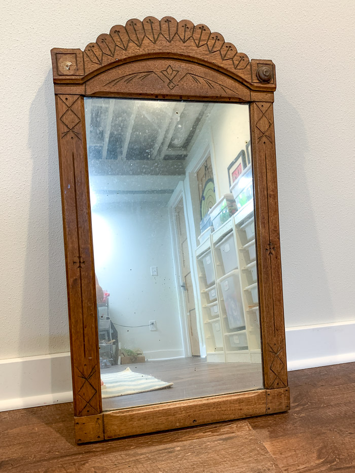 This flea market find mirror had cute details, but it was missing the round applique detail in the top left corner. Learn how to make a replacement applique with FastCast resin in this post.