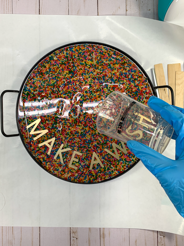 Pour a third layer of EnviroTex Lite over the candy sprinkle tray and vinyl words.
