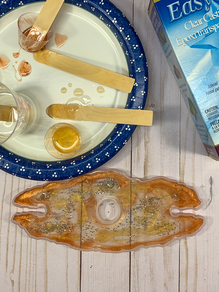 The first resin layer in this DIY wine glass holder features EasyCast resin with glass glitter mixed in, as well as resin colored with gold and copper pigments.