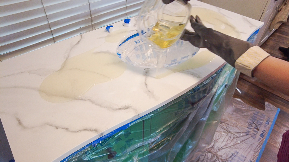 pouring resin on countertop for a bathroom counterop makeover