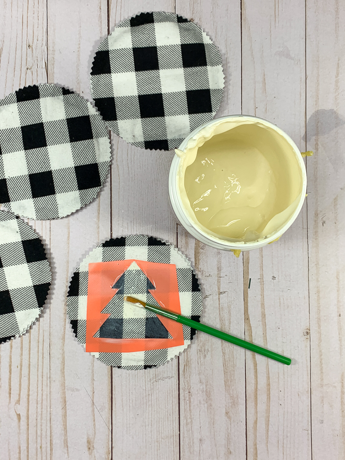 Paint a thin layer of Fiber-Lok on the back of the coasters.
