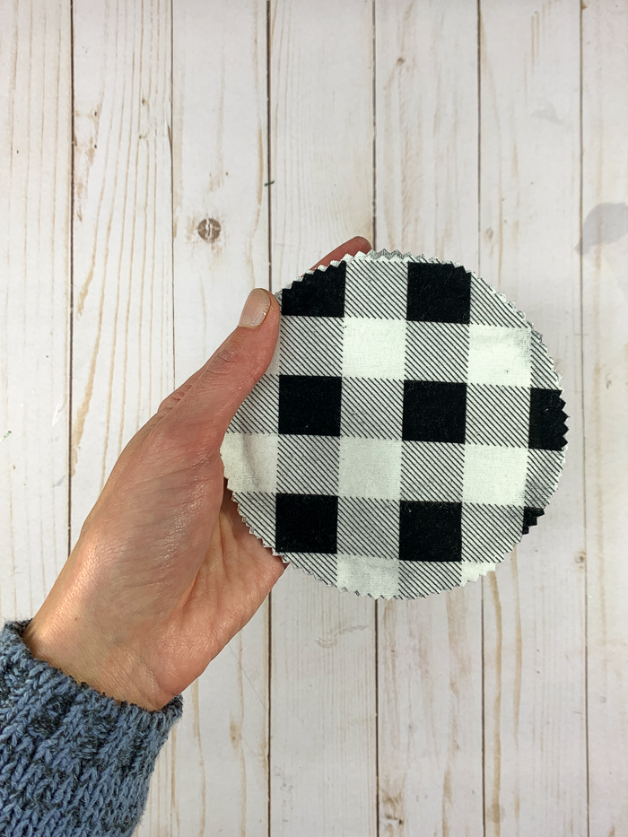 Pinch together the edges of the flannel pieces when making no-sew coasters.