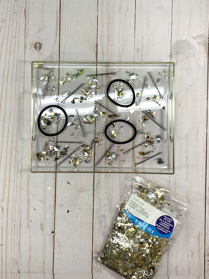 Add glitter confetti to the acrylic tray.