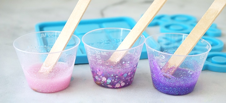 Mixing cups filled with glitter and resin