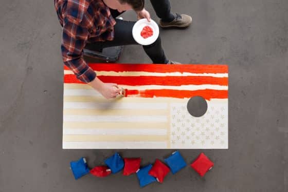 paint red stripes on American flag cornhole board
