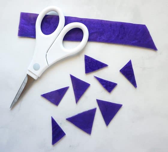 Scissors and pieces of purple resin strip