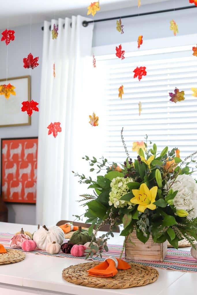 fall table with resin leaves hanging above