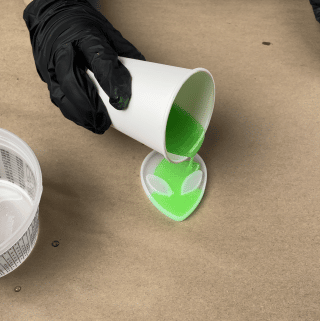 Resin-mixed-with-dye-and-glow-in-the-dark-powder-poured-into-alien-mold