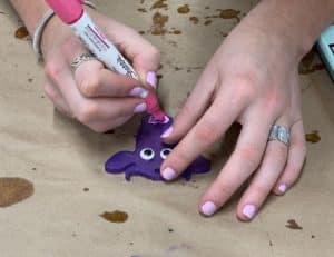 Sharpie used to draw on purple cow magnet.
