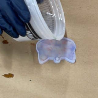 Resin-being-poured-into-a-cat-face-shaped-mold