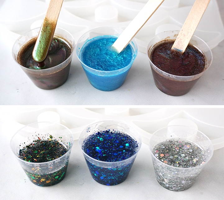 Resin mixtures in cups with Color Creator pigments and glitter