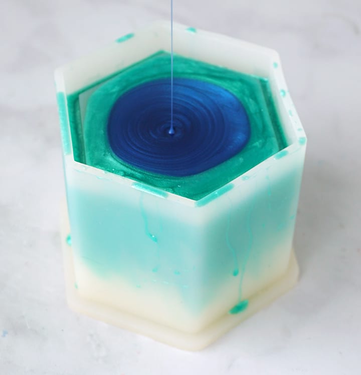 Blue resin pouring into planter mold