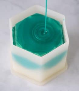 green resin pouring into mold