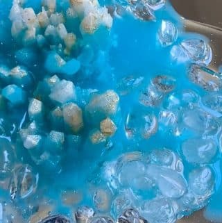 resin-and-crystals-being-adhered-to-a-mirror-for-geode-resin-art