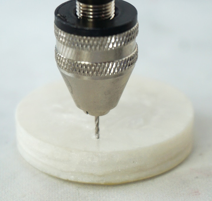 hand drilling a hole in the back of shaker charm